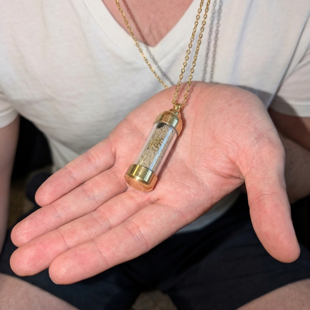 Person holding Temple Mount pendant in hand